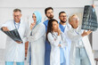 © Pixel-Shot - Team of doctors studying MRI scan in clinic
