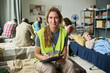 © pressmaster - Portrait of Caucasian middle aged woman volunteer writing notes in emergency shelter among displaced adults, supporting crisis care. Useful for humanitarian aid and relief campaigns