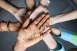 © Seventyfour - Close up of diverse adult hands stacking together, symbolizing teamwork, unity, collaboration in workplace. Ideal for corporate culture, inclusion, partnership messaging