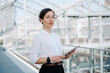 © Westend61 - Portrait of a confident businesswoman holding tablet