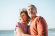 © Westend61 - Smiling blond woman with man at beach on sunny day