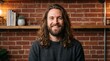 © Анастасия Калинина - Happy man with long hair smiling in cozy brick interior