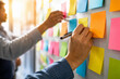© Said - Close up of hands writing and placing sticky notes