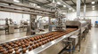 © Aura Stock - Industrial robotic chocolate sorting line in food processing facility.