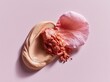 © Alper AI - Creamy foundation swatch with crushed blush and delicate petal on pink