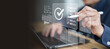 © Kornkanok - Corporate overseeing digital document management ensuring strict compliance during routine workflow inspecting detailed checklist needing final approval.