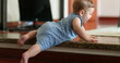 © Marco - Baby trying to climb home step staircase infant boy learning to crawl surface