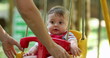 © Marco - Cute adorable baby boy at park swing outdoors mom pushing infant son at playground swing