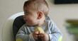 © Marco - Cute baby infant eating piece of apple fruit