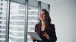© stockbusters - Wealthy lady walking corporate building corridor using tablet stepping closeup
