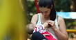 © Marco - Candid mother holding baby infant boy outside at park
