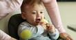 © Marco - Casual candid family scene of parent putting meal table for baby to eat
