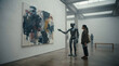 © peno - Humanoid Robot Guide With Museum Visitor In Contemporary Art Gallery Viewing Abstract Painting