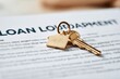 © The Little Hut - Close-up of golden house key and keychain on loan documents, symbolizing homeownership and mortgage agreement