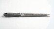© Ulum - Sharp metal file tool with black handle on white background.