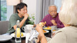© blueringmedia - Multi-Generational Asian Family Sharing Breakfast and Conversation at Home