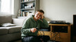© Rendara Studio - Frustrated young man untangling messy audio cables beside a turntable at home
