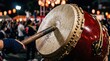 © Ranu - Taiko drum played with wooden stick at traditional festival.