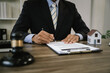 © Kieng - Lawyer holding a judge's gavel over a house model, symbolizing real estate law, property disputes, legal justice, and contract enforcement.