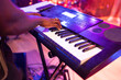 © AresStudio Belen y Carlos/Stocksy - Musician playing electronic keyboard at live event