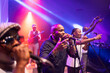 © AresStudio Belen y Carlos/Stocksy - Black musicians performing live concert with microphones and