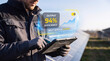 © Thimira - man uses tablet with glowing solar farm interface to track panel output efficiency, visualize grid feed chart, monitor maintenance schedule status, and manage renewable plant operations