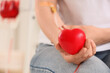 © Pixel-Shot - Person donating blood holding a red heart, medical procedure and healthcare concept, blood donation campaign