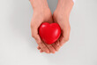 © Pixel-Shot - Human hands holding a red heart, health care and medical support, love and compassion, isolated on a white background