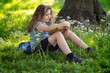 © Volodymyr - Kid studying outdoors feels calm and peaceful. Smart kid enjoys storytelling in nature. Focused educational kid reads vintage book. Kid portrait shows thoughtful expression.