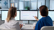 © Andrey Popov - Two Healthcare Workers Discuss Patient Information