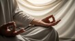 © Angavlan - Senior person meditating  with hands in prayer position. Tranquil ambiance created by soft draped fabric, highlighting the peaceful moment shared between  in meditation.