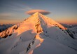 © Apel - Dramatic sunset over jagged mountain peaks with snow.