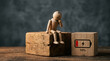 © ANMZAKARIA - Mental health burnout concept image | Tired wooden mannequin sitting with low battery | Emotional exhaustion and lack of energy | Physical fatigue metaphor with battery icon