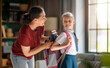 © Konstantin Yuganov - Happy Mother Helping Daughter Get Ready for School Morning Routine