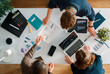 © Konstantin Yuganov - Team Collaboration in Modern Office Analyzing Financial Charts a Business Data