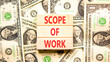 © Dzmitry - Scope of work words symbol. Concept words Scope of work on beautiful wooden blocks. Beautiful dollar bills background. Dollar bills. Business motivational and scope of work concept. Copy space.