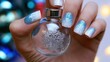 © vasyl pshyk - Holding a small glass ornament with a snowflake design and painted nails during the winter season