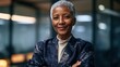 © PixelPulse Creative - Confident mature businesswoman with short grey hair posing in a modern office environment