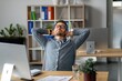© Prostock-studio - Calm Caucasian Man Appearing Relaxed Sitting At Desk With Hands Behind Head In Contemporary Office Environment, Taking A Break. Business Concept.