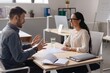 © Prostock-studio - Smiling Interracial Professional Couple Engaged In Animated Discussion Over Business Strategies At Modern Office With Natural Light And Minimalist Decor, Creating Collaborative Atmosphere.