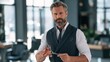 © Alexander LW - Bearded man in vest holds scissors with focused expression