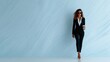 © svastix - A stylish and confident woman strides forward in a sharp business suit, holding a coffee cup, embodying a sophisticated blend of professionalism and urban elegance.