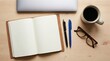 © Rendara Studio - Top view of laptop journal pens glasses and coffee on light wooden workspace