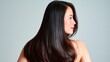 © svastix - A stunning profile view of a woman showcasing her luxurious long, shiny black hair against a soft neutral background, exuding elegance and confidence in her appearance.