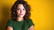© svastix - A portrait of a confident young woman with curly hair smiling softly against a bold yellow backdrop, radiating warmth and positivity, ideal for showcasing empowerment and beauty.