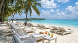 Luxury tropical beach resort with sun loungers and cocktails