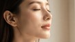 © TransPicHub - A close-up profile of a serene woman with closed eyes, glowing skin, and soft natural light highlighting her calm expression.