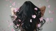 © pornsawan - Pink flower on long hair of beauty woman in studio,spring or summer concept,creative bright image for advertising products for hair,copy space,sakura,cherry blossom,Bridal hairstyle with real flowers.