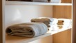 © nanang - Folded towels and linens neatly stacked on wooden shelf