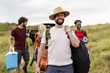 © milanmarkovic78 - Group of friends having a day outdoors with guitar and cooler